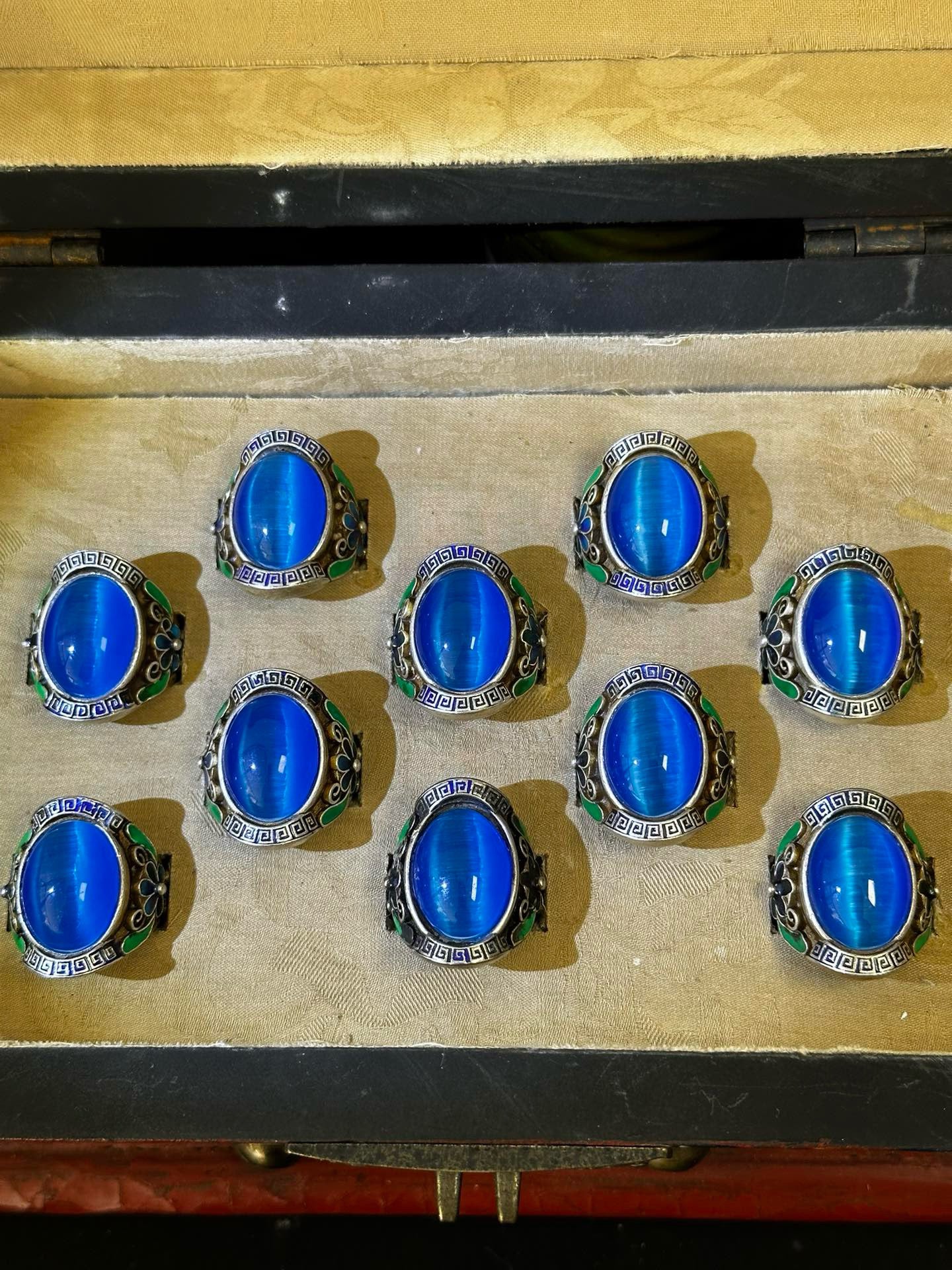 A box of Chinese antique blue cat eye rings