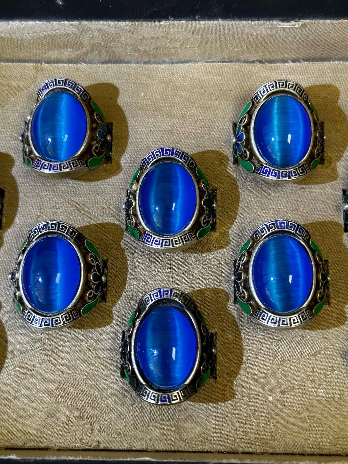 A box of Chinese antique blue cat eye rings