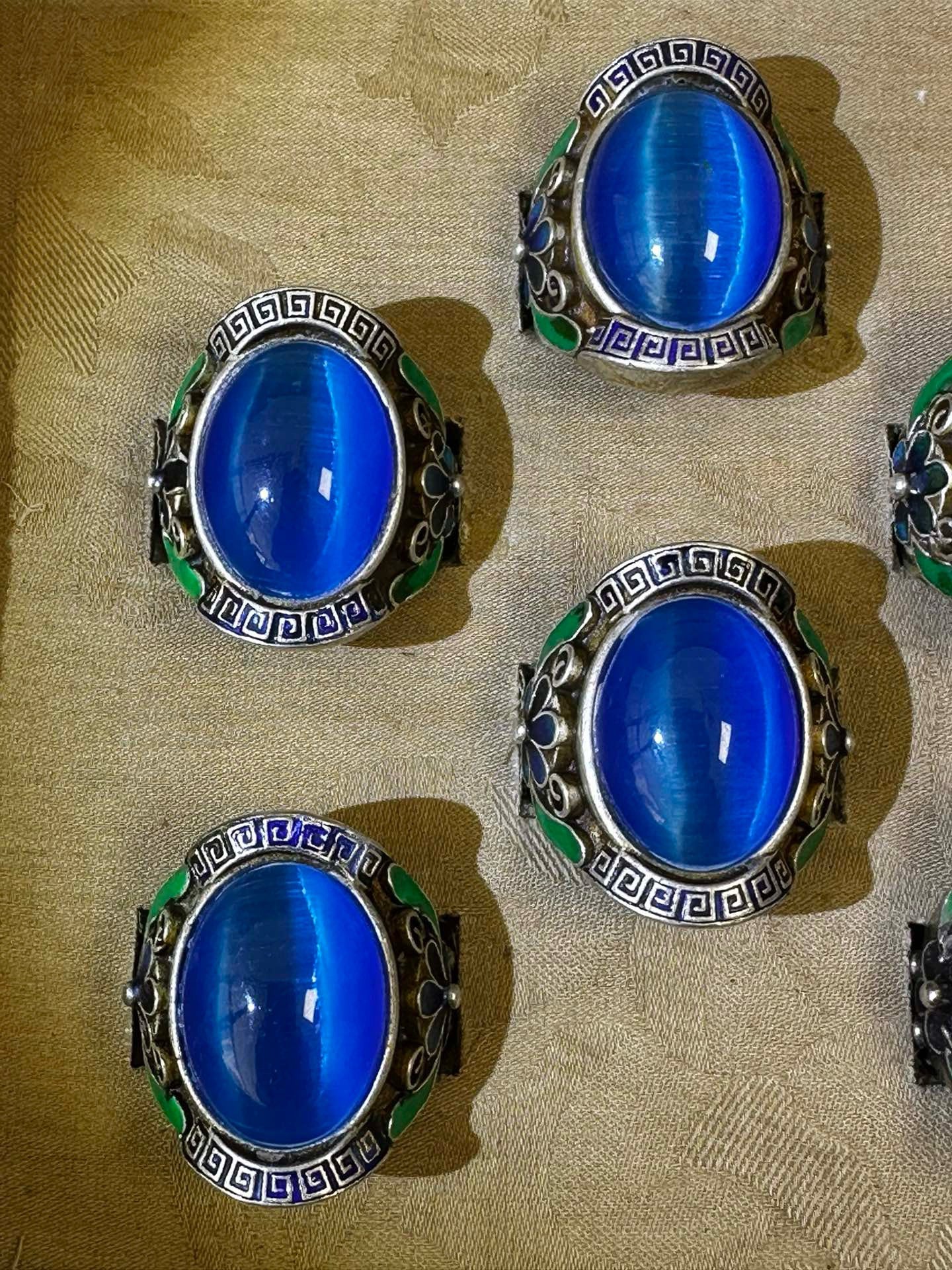 A box of Chinese antique blue cat eye rings