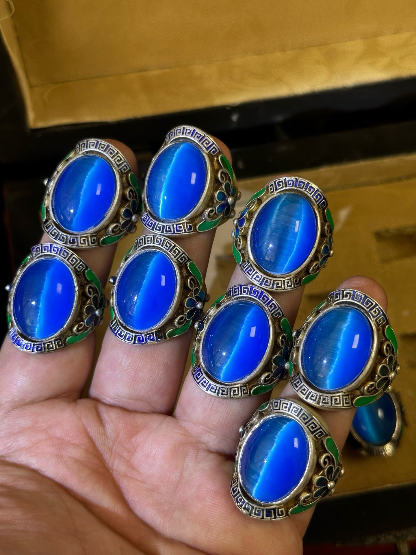 A box of Chinese antique blue cat eye rings