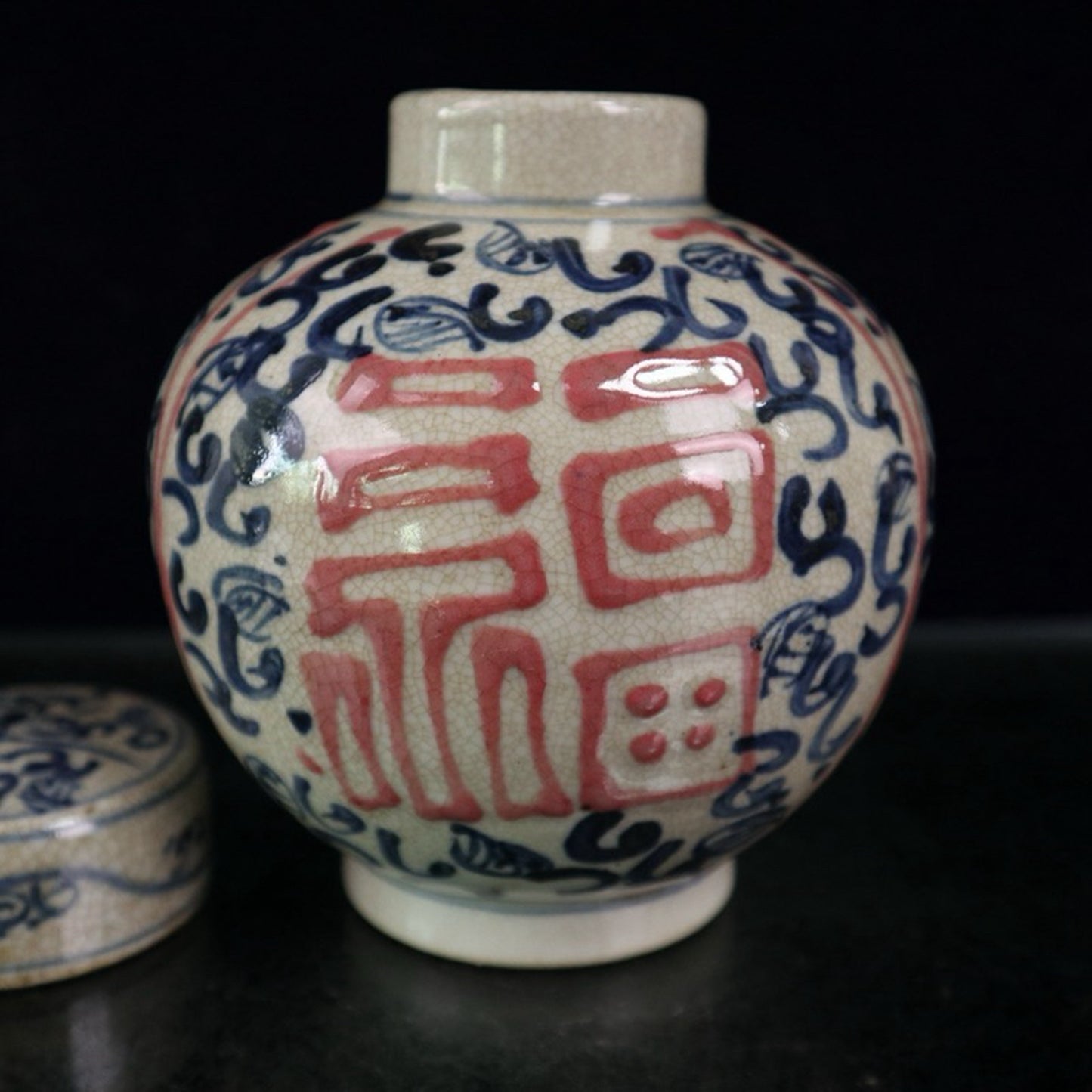 Open-piece blue and white glazed jar with a red blessing pattern lid