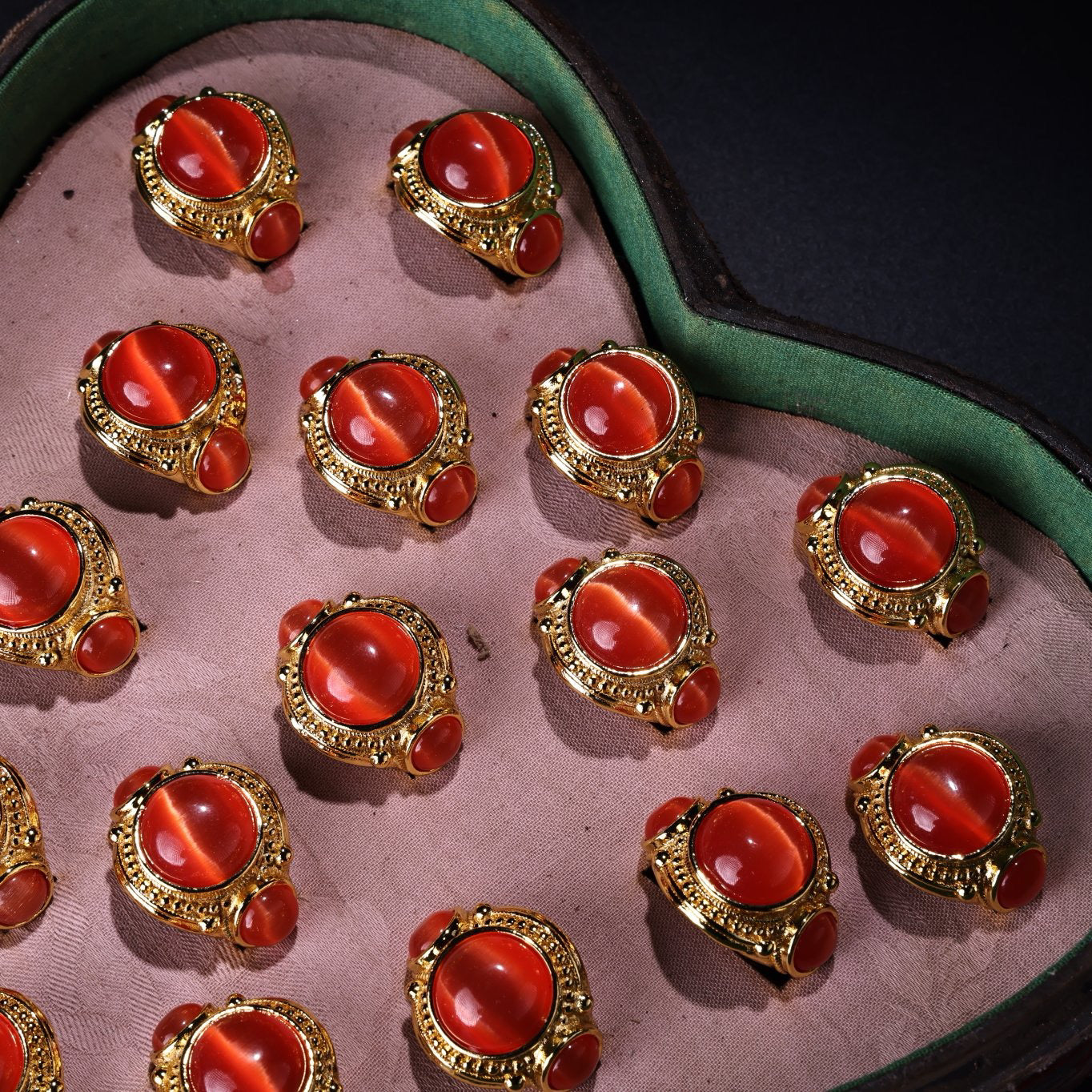 A box of Chinese antique red cat's eye stone rings