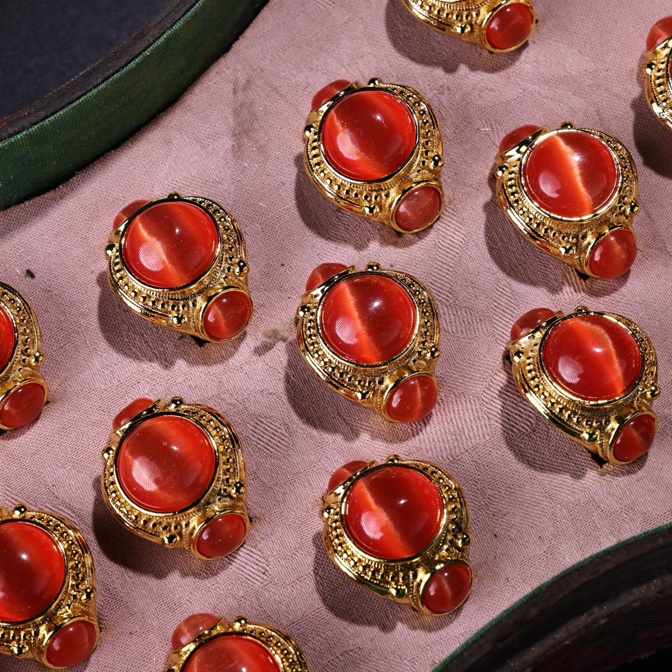 A box of Chinese antique red cat's eye stone rings