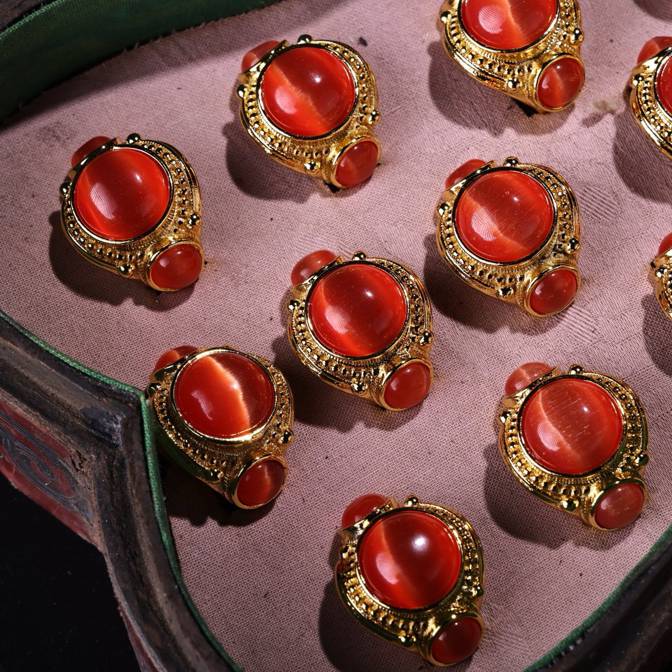 A box of Chinese antique red cat's eye stone rings