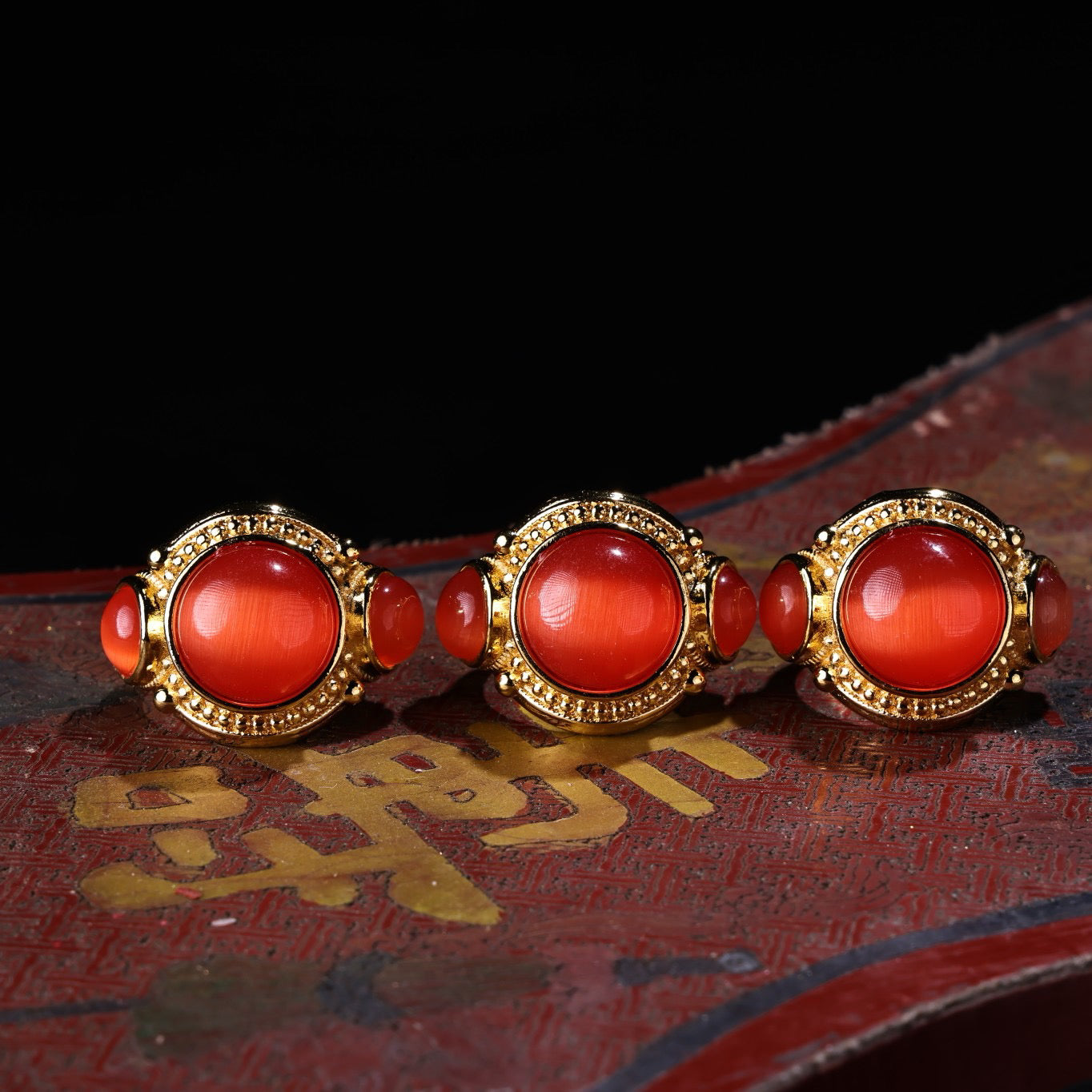 A box of Chinese antique red cat's eye stone rings