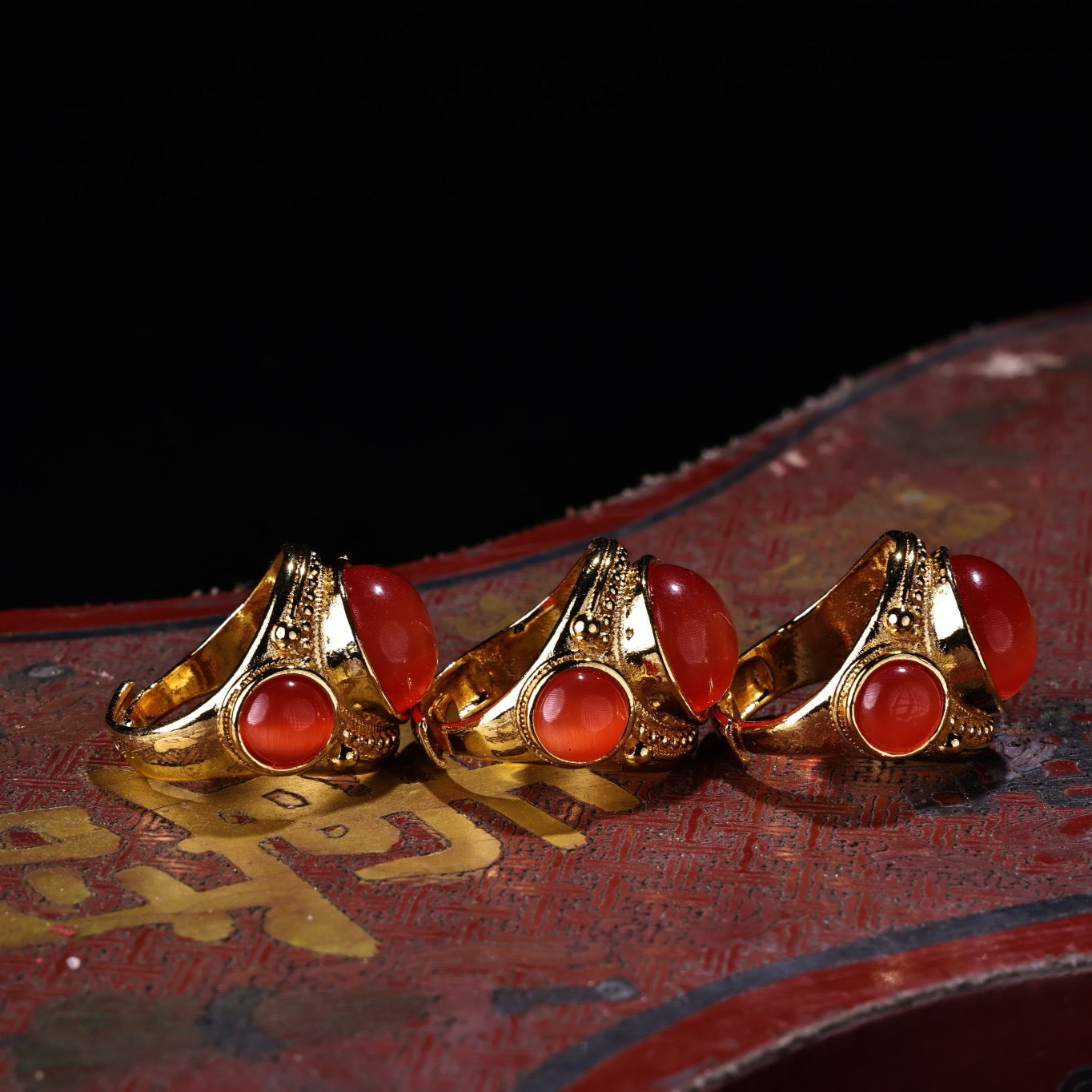 A box of Chinese antique red cat's eye stone rings