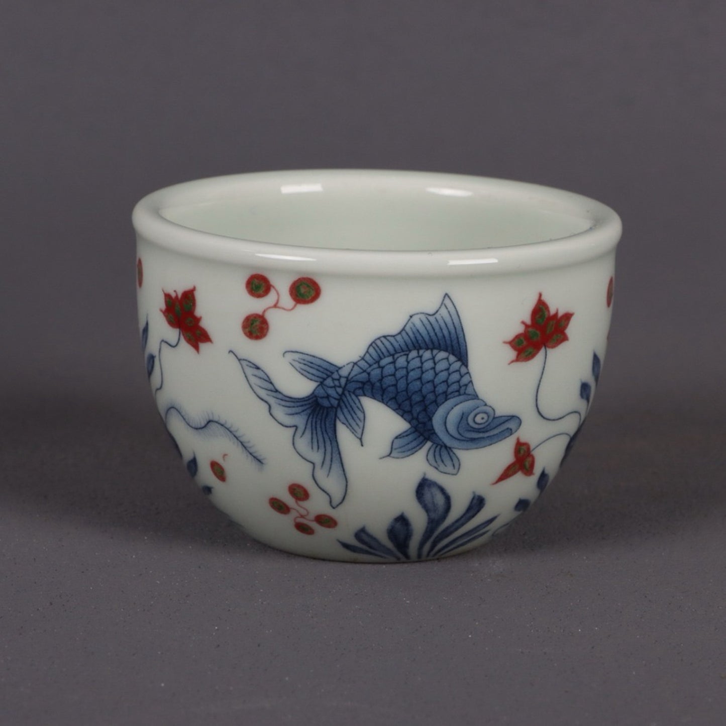 Blue and white glazed red fish and algae patterned small mouth cup