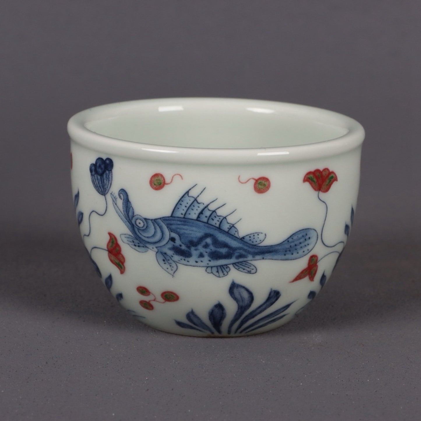 Blue and white glazed red fish and algae patterned small mouth cup