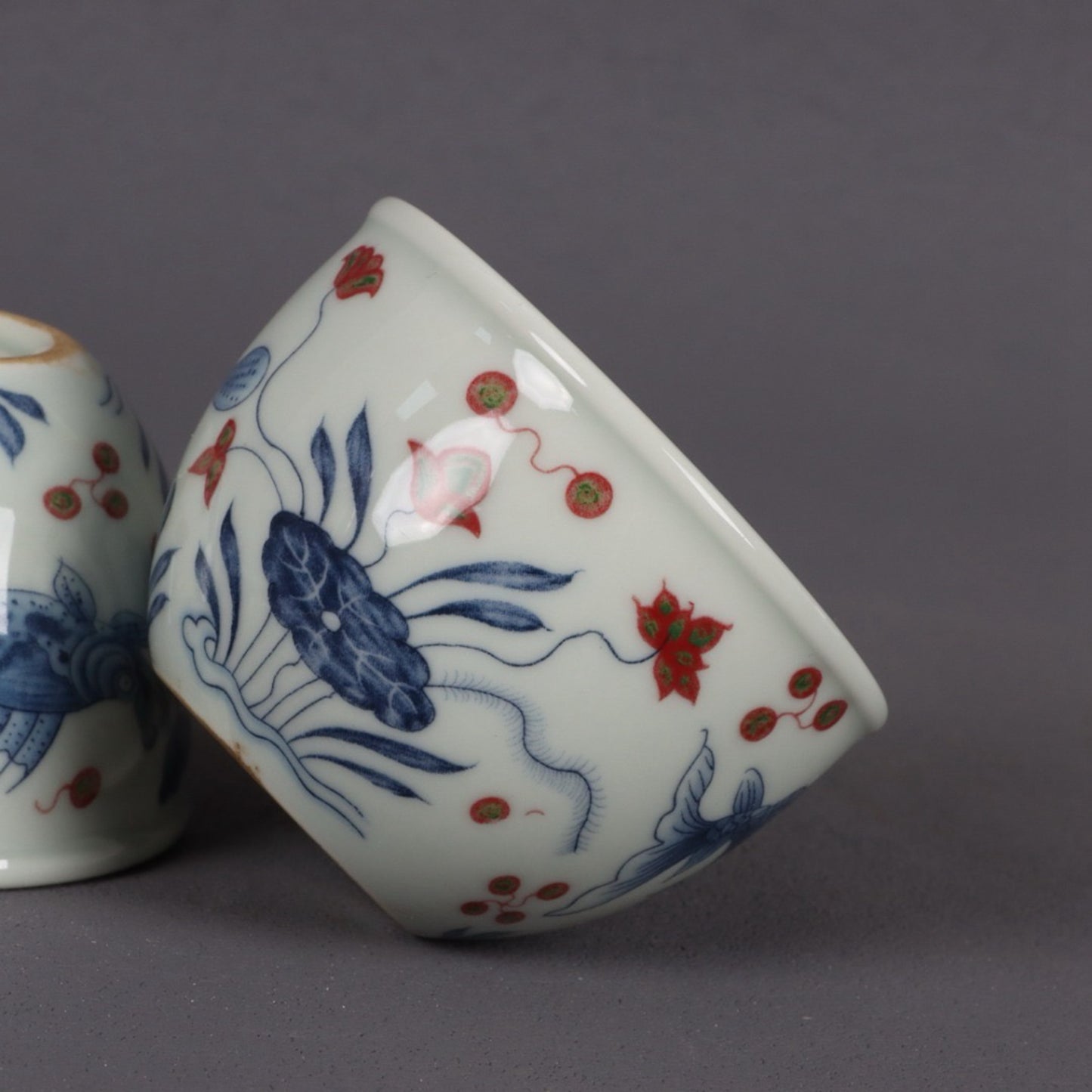 Blue and white glazed red fish and algae patterned small mouth cup