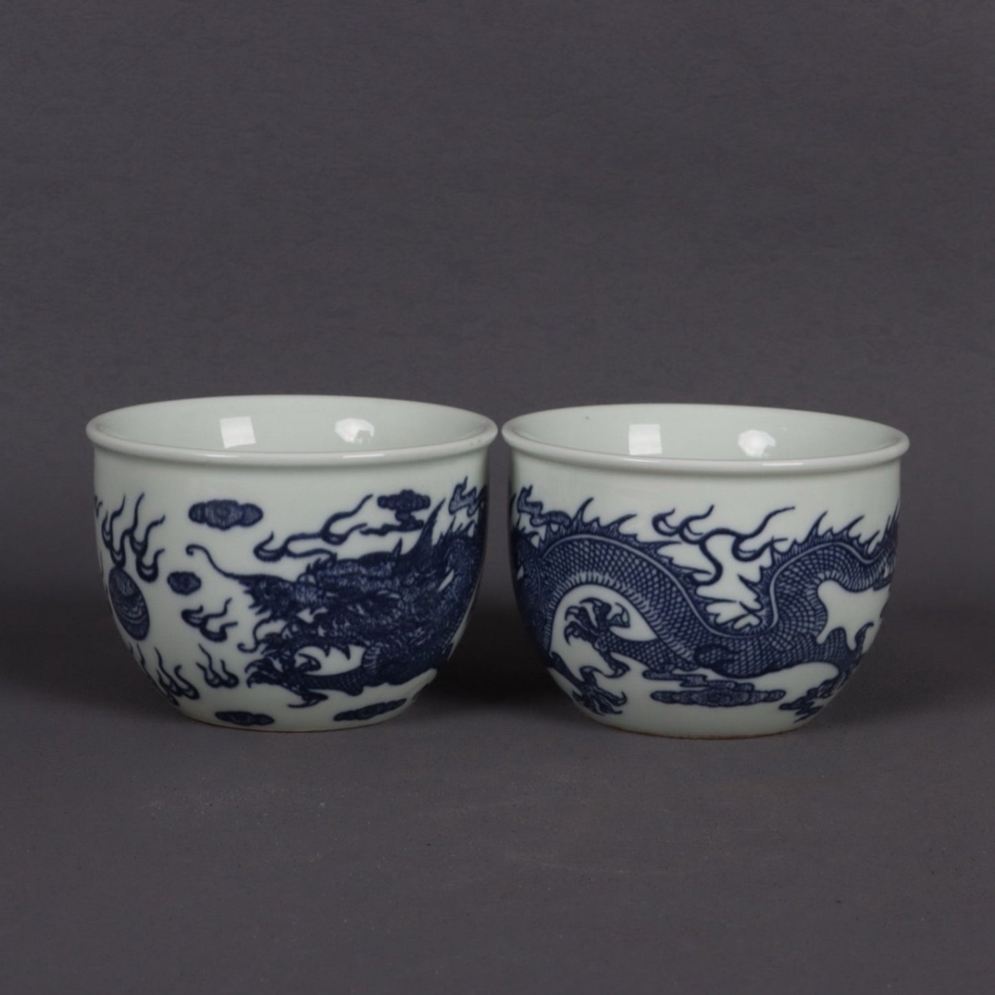 A pair of blue and white dragon patterned cups