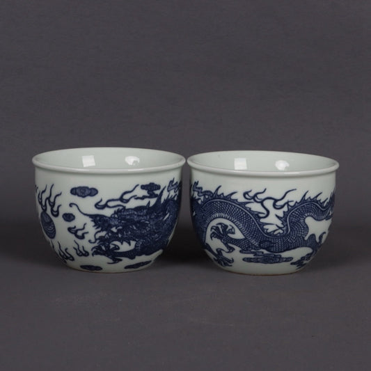 A pair of blue and white dragon patterned cups