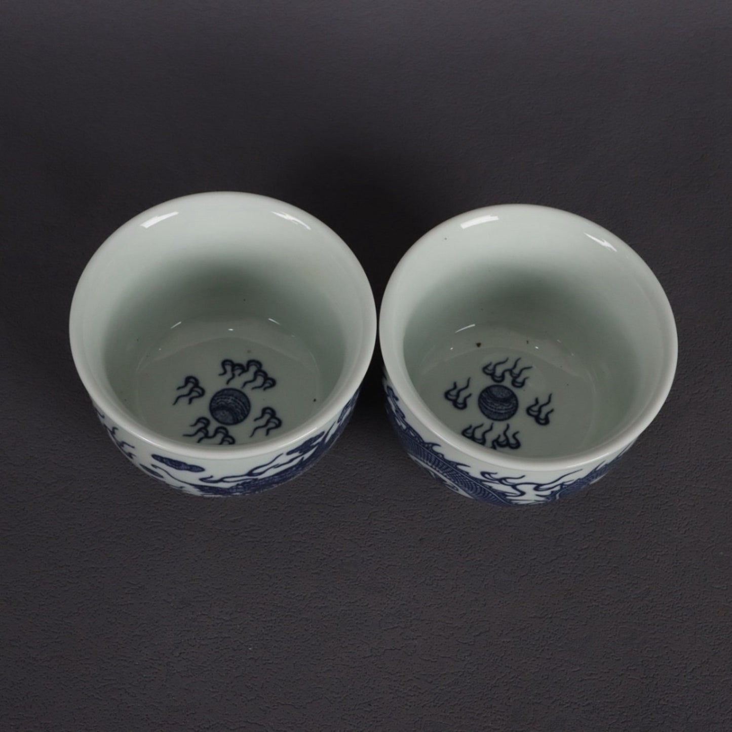 A pair of blue and white dragon patterned cups