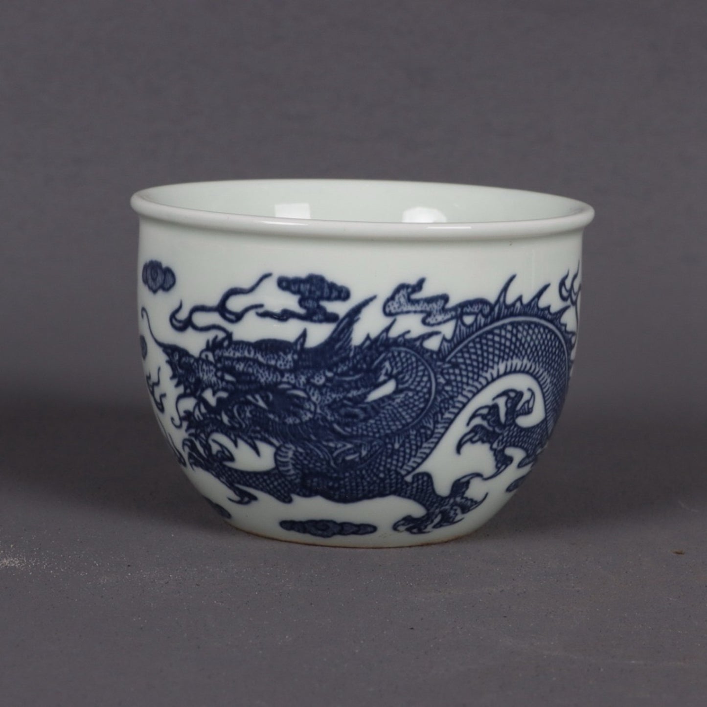 A pair of blue and white dragon patterned cups