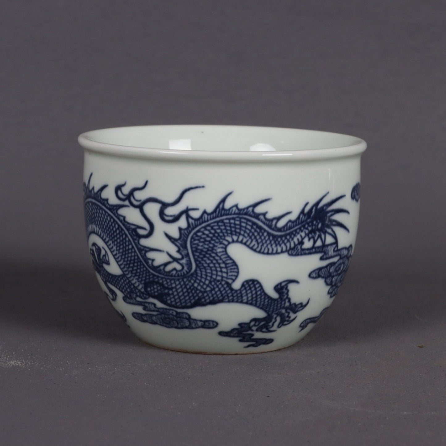 A pair of blue and white dragon patterned cups