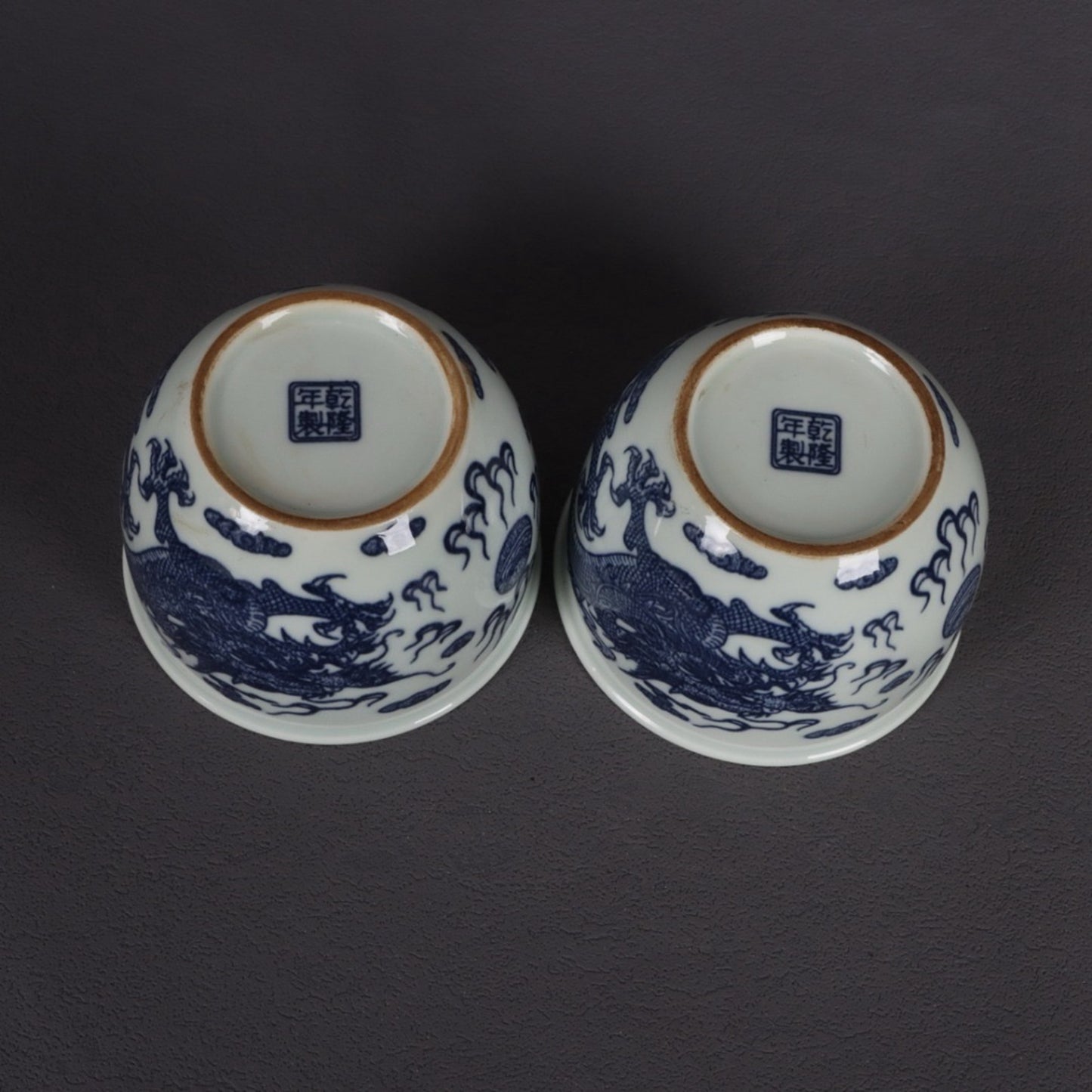 A pair of blue and white dragon patterned cups