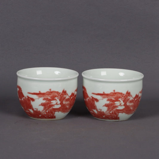 A pair of glazed red landscape patterned mouth cups