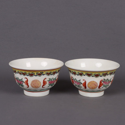 A pair of pink longevity patterned bowls