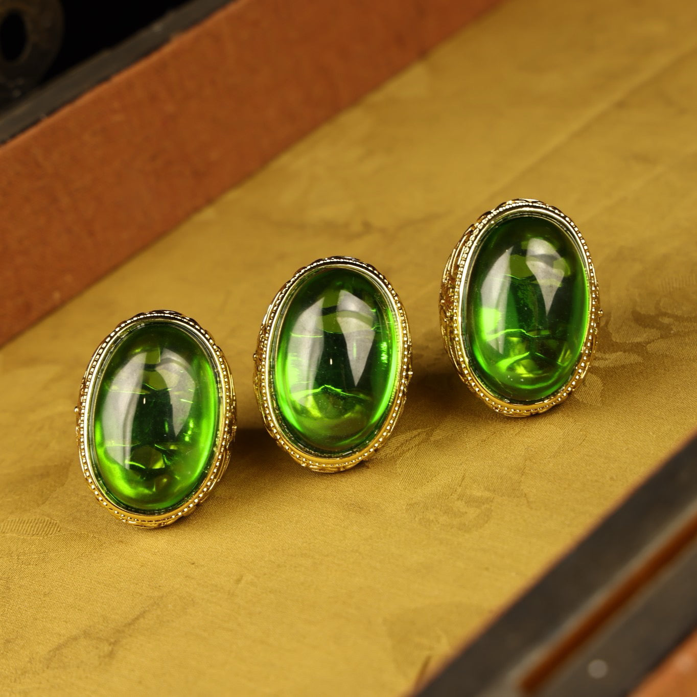 A box of Chinese antique grandmother emerald rings