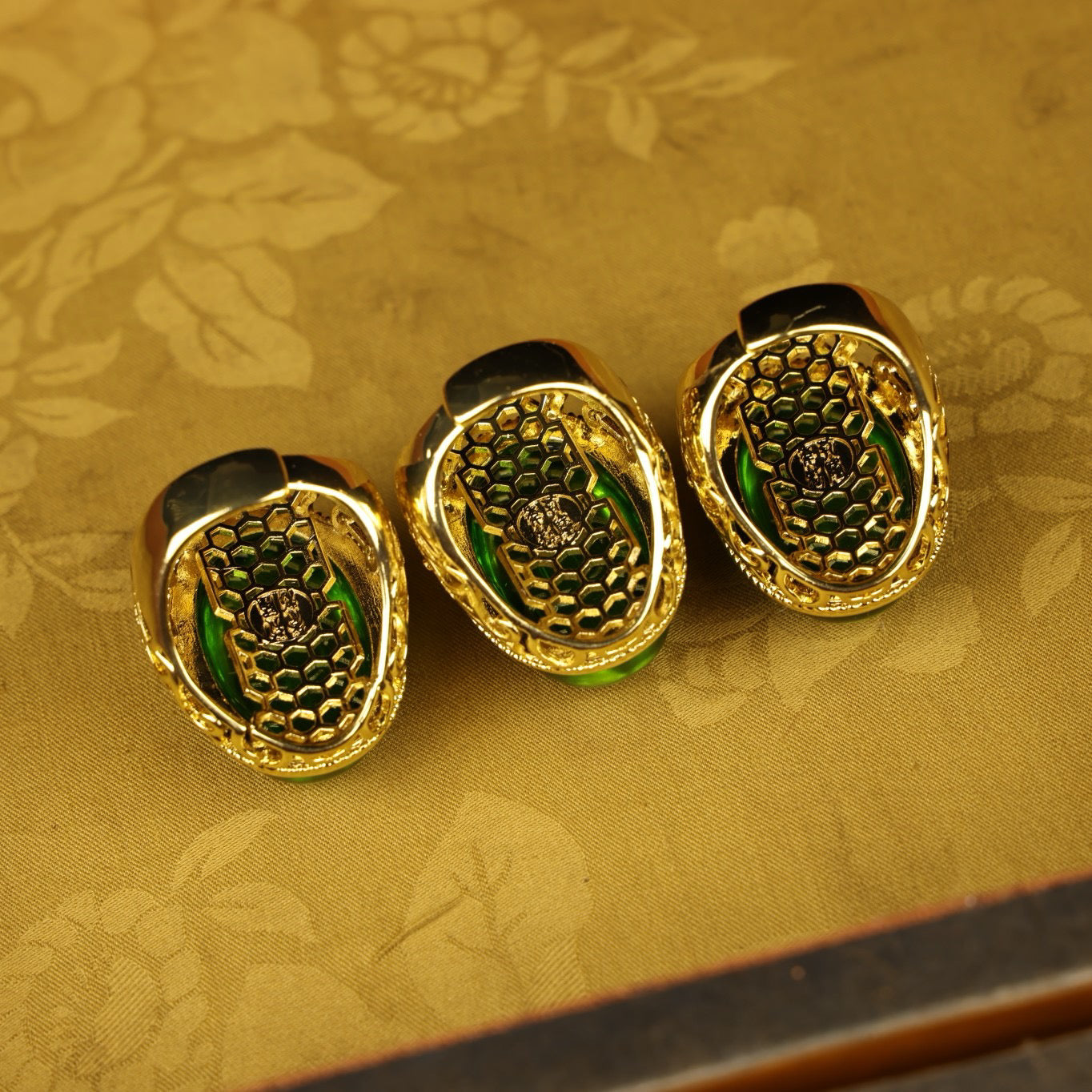 A box of Chinese antique grandmother emerald rings