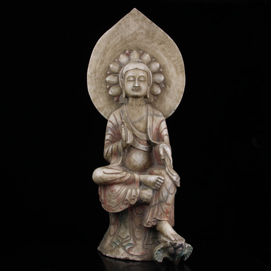 A sitting Buddha statue carved and painted on Chinese antique jade during the Northern Qi Dynasty