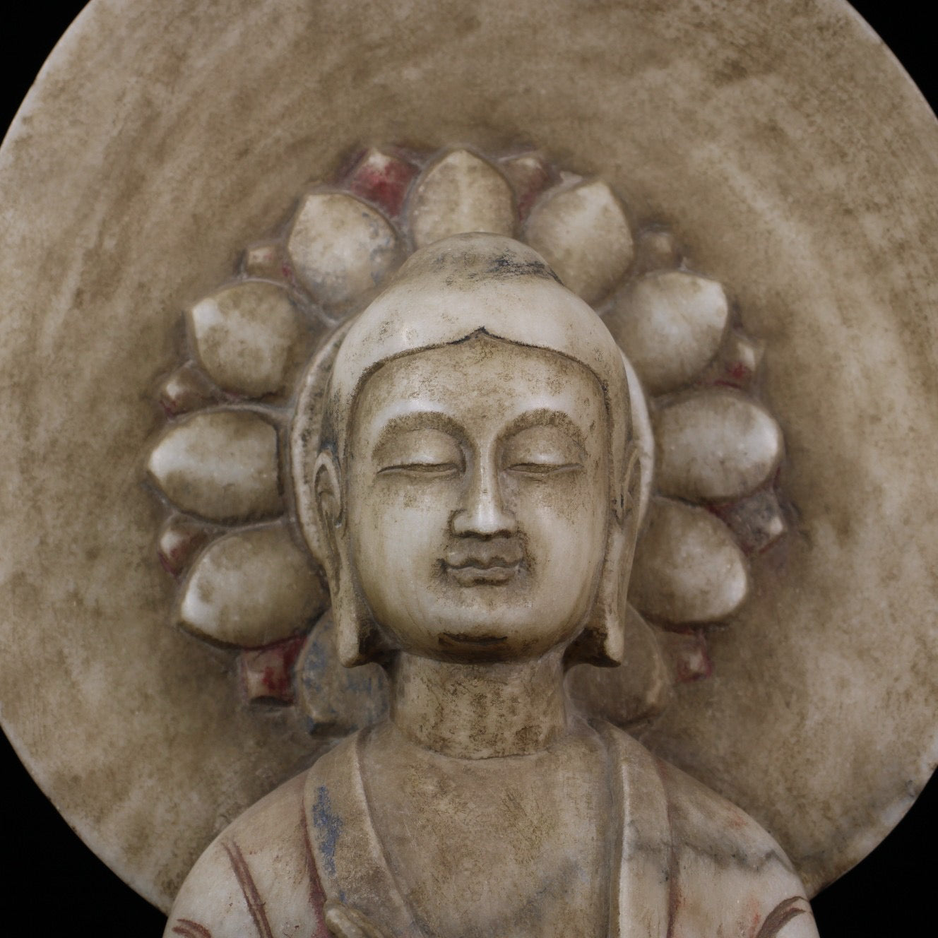 A sitting Buddha statue carved and painted on Chinese antique jade during the Northern Qi Dynasty