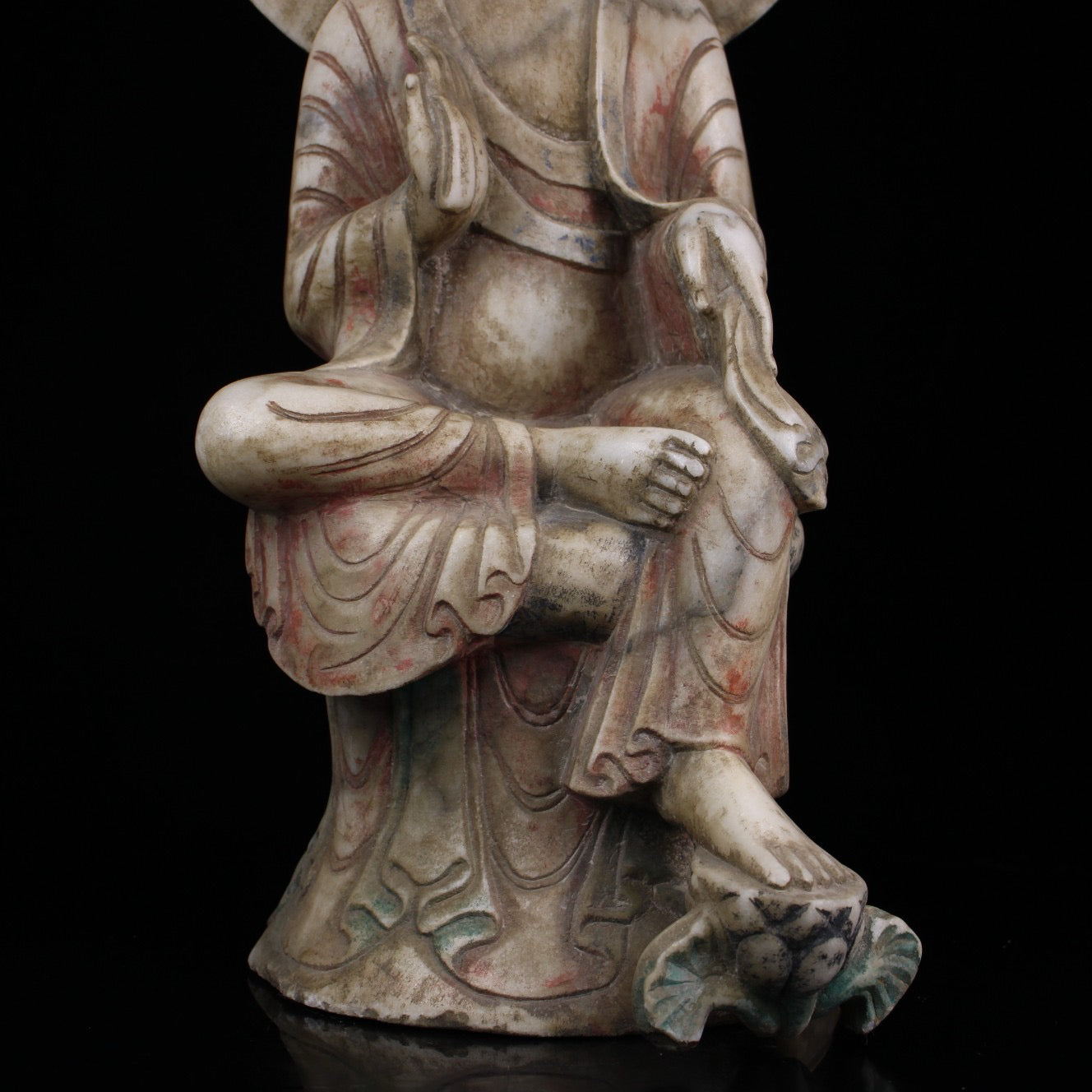 A sitting Buddha statue carved and painted on Chinese antique jade during the Northern Qi Dynasty