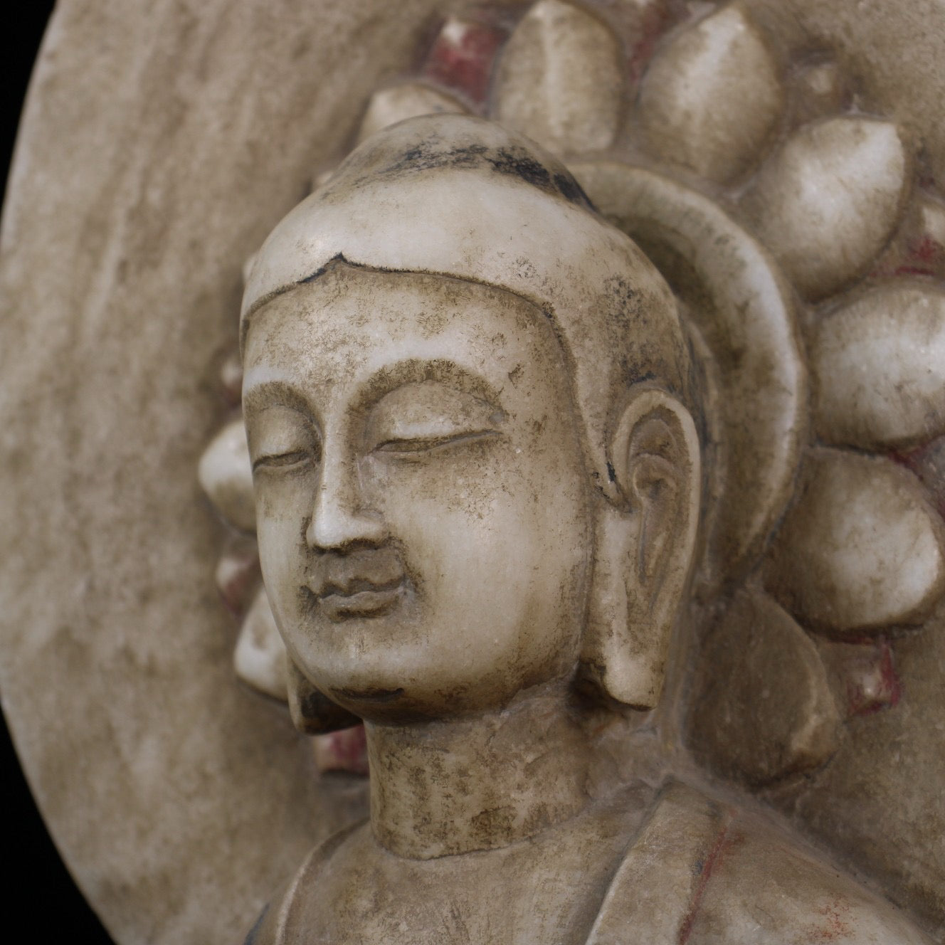 A sitting Buddha statue carved and painted on Chinese antique jade during the Northern Qi Dynasty