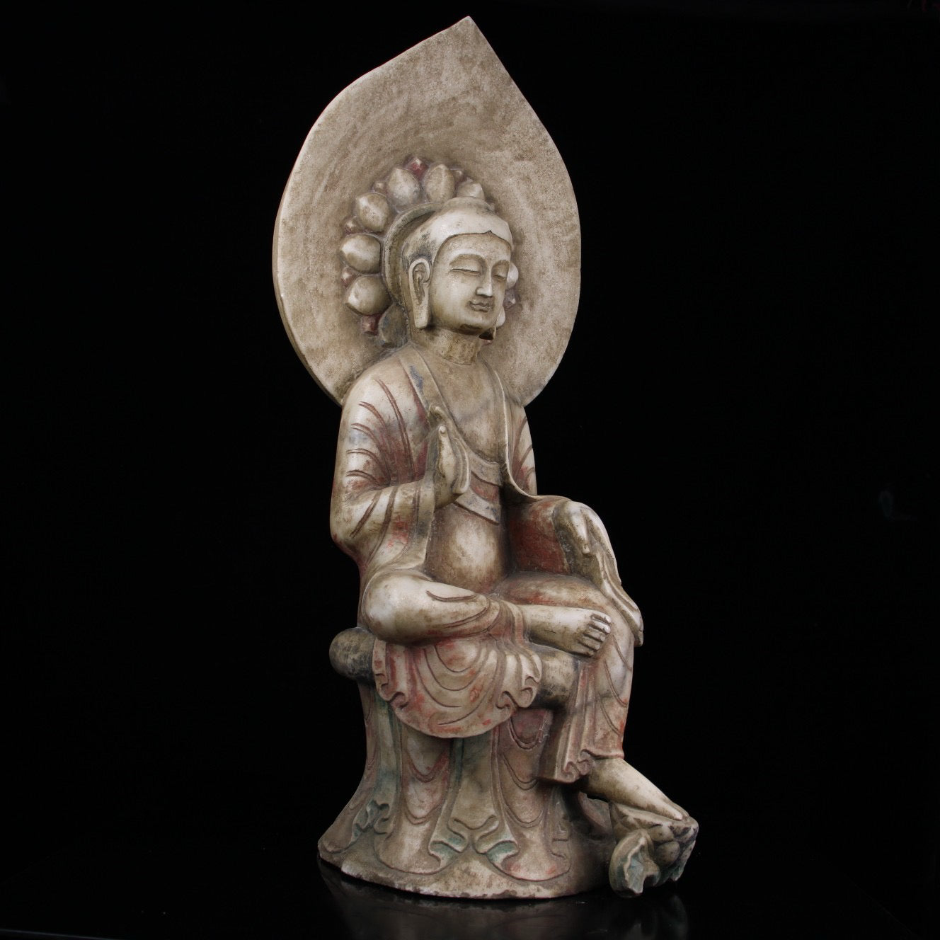 A sitting Buddha statue carved and painted on Chinese antique jade during the Northern Qi Dynasty