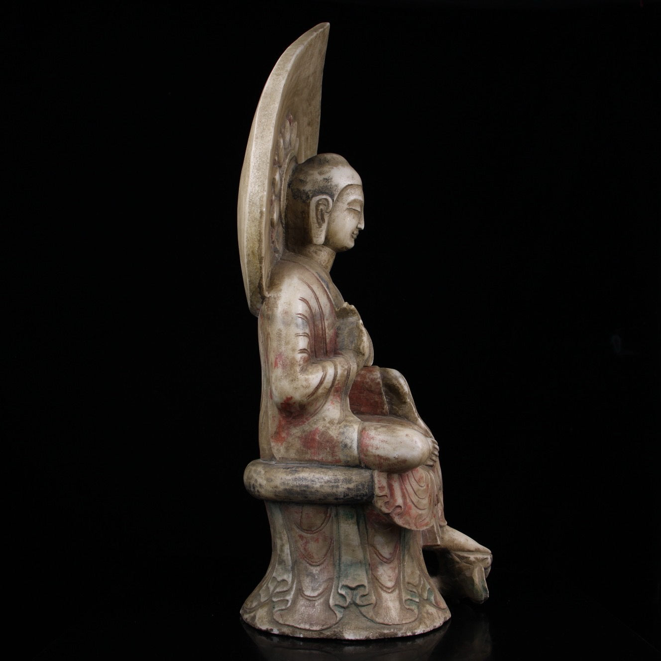 A sitting Buddha statue carved and painted on Chinese antique jade during the Northern Qi Dynasty