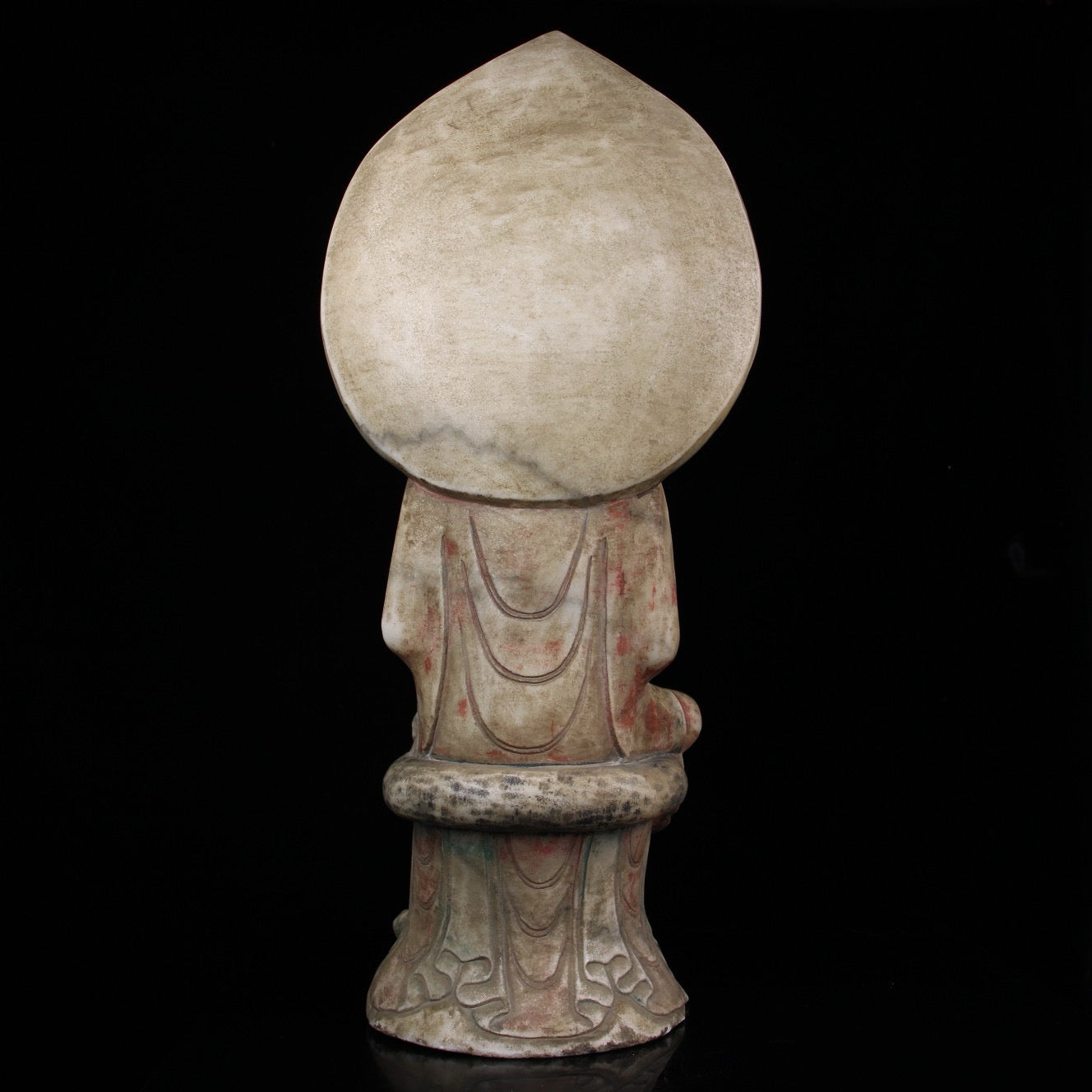 A sitting Buddha statue carved and painted on Chinese antique jade during the Northern Qi Dynasty