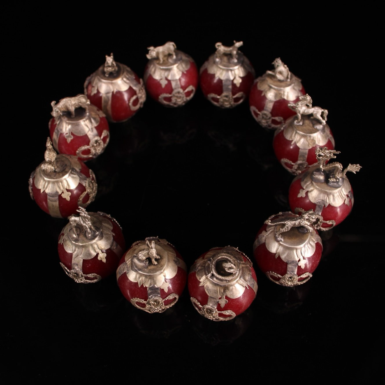 A set of Chinese antique silver wrapped jade zodiac balls