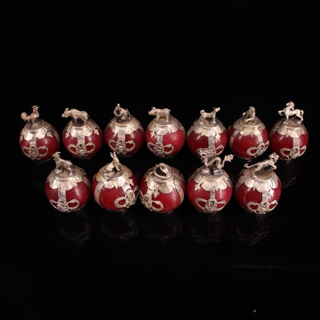 A set of Chinese antique silver wrapped jade zodiac balls