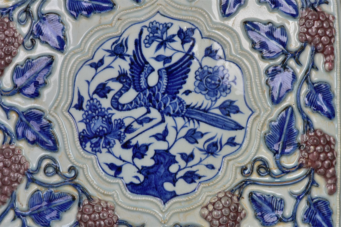 Chinese antique blue and white glazed red relief bottle with multiple grape patterns and a square shape