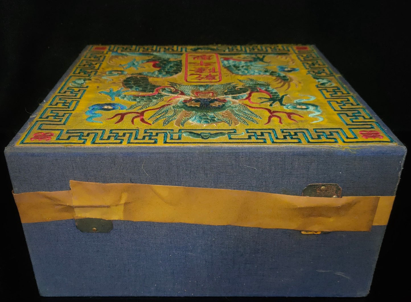Old white tea inside the brocade box