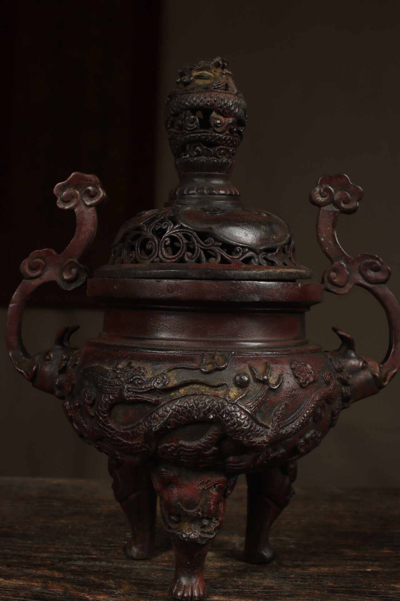 A Chinese antique pure copper incense burner with three legs and two dragons