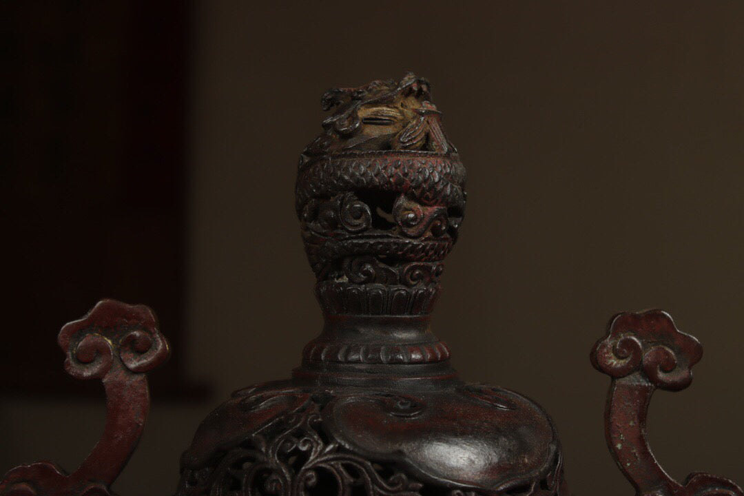 A Chinese antique pure copper incense burner with three legs and two dragons