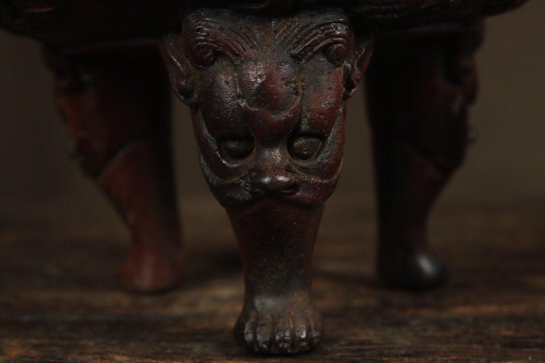 A Chinese antique pure copper incense burner with three legs and two dragons