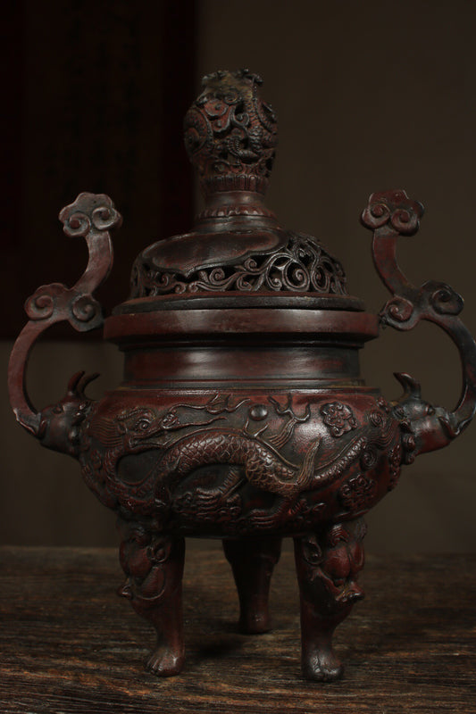 A Chinese antique pure copper incense burner with three legs and two dragons