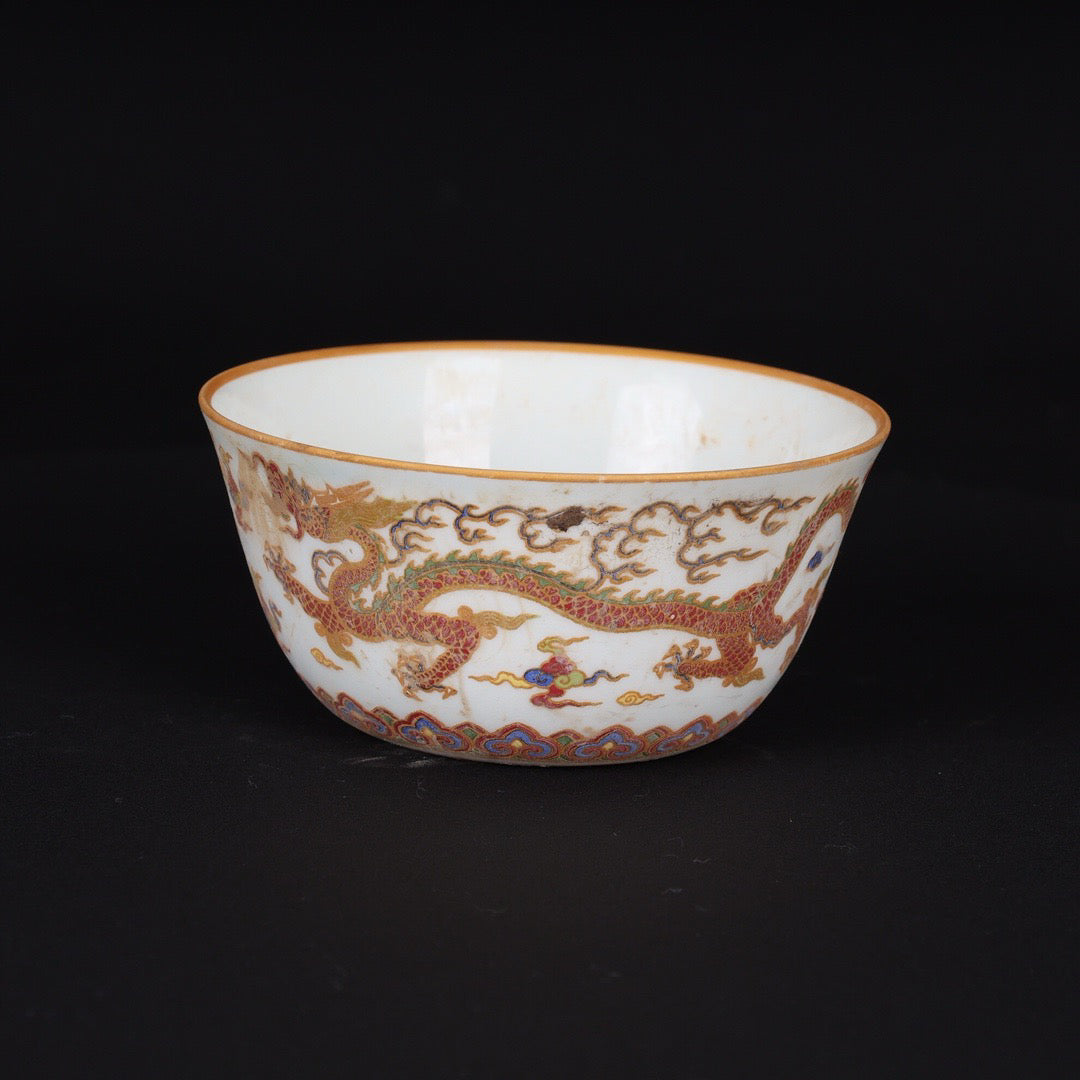 A pair of Chinese antique flat bottomed cups with patterns of double dragons playing with pearls