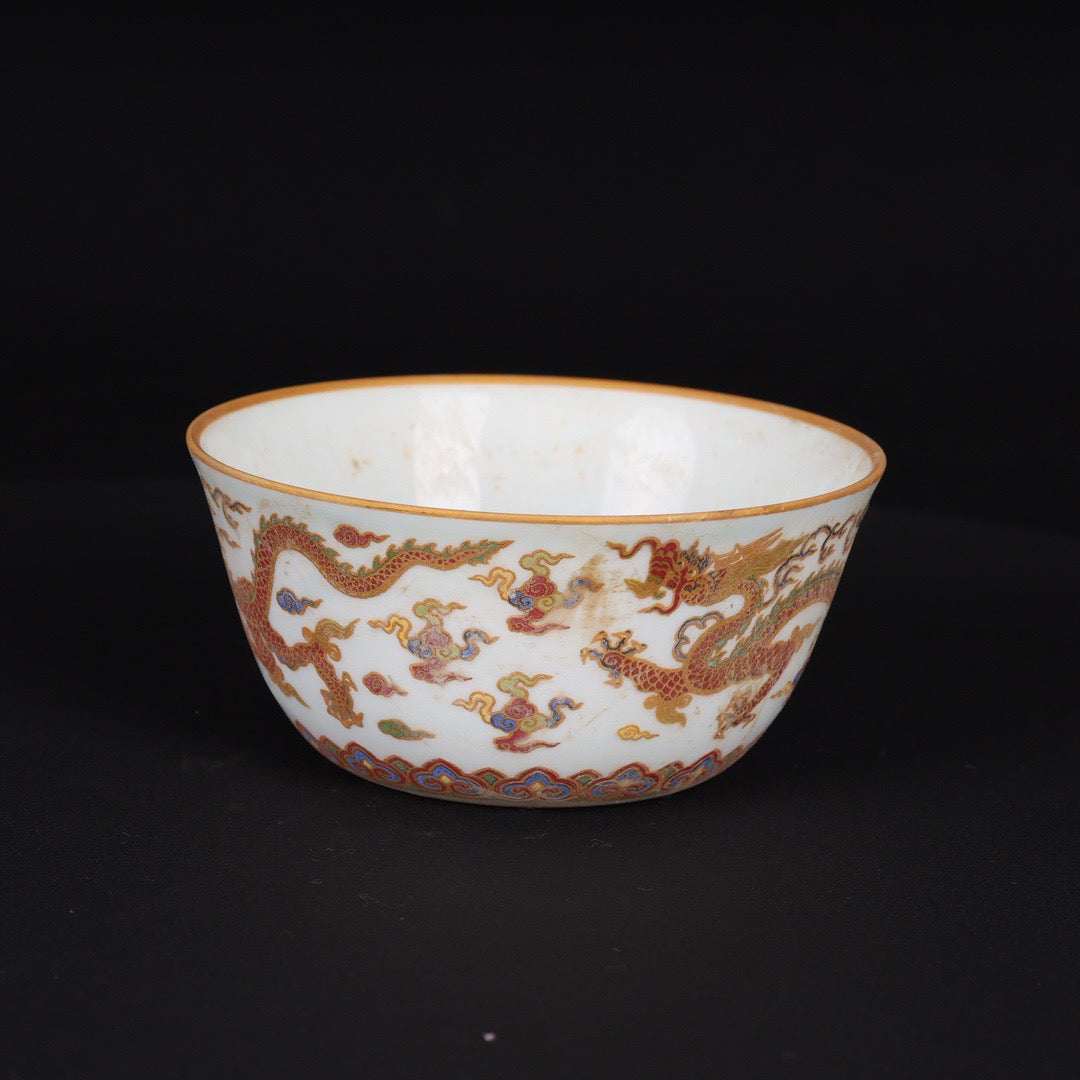 A pair of Chinese antique flat bottomed cups with patterns of double dragons playing with pearls