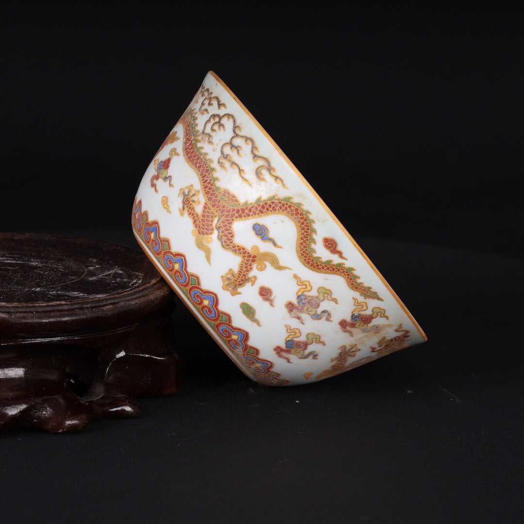 A pair of Chinese antique flat bottomed cups with patterns of double dragons playing with pearls