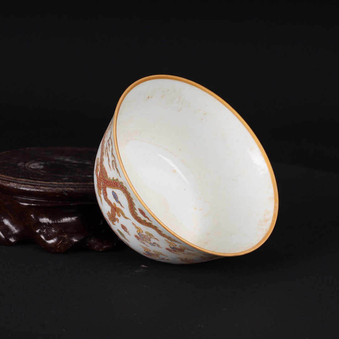 A pair of Chinese antique flat bottomed cups with patterns of double dragons playing with pearls