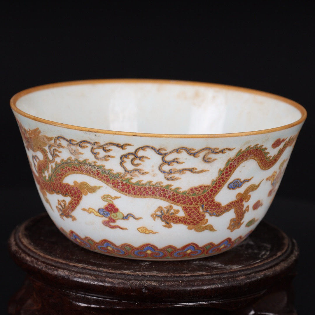 A pair of Chinese antique flat bottomed cups with patterns of double dragons playing with pearls