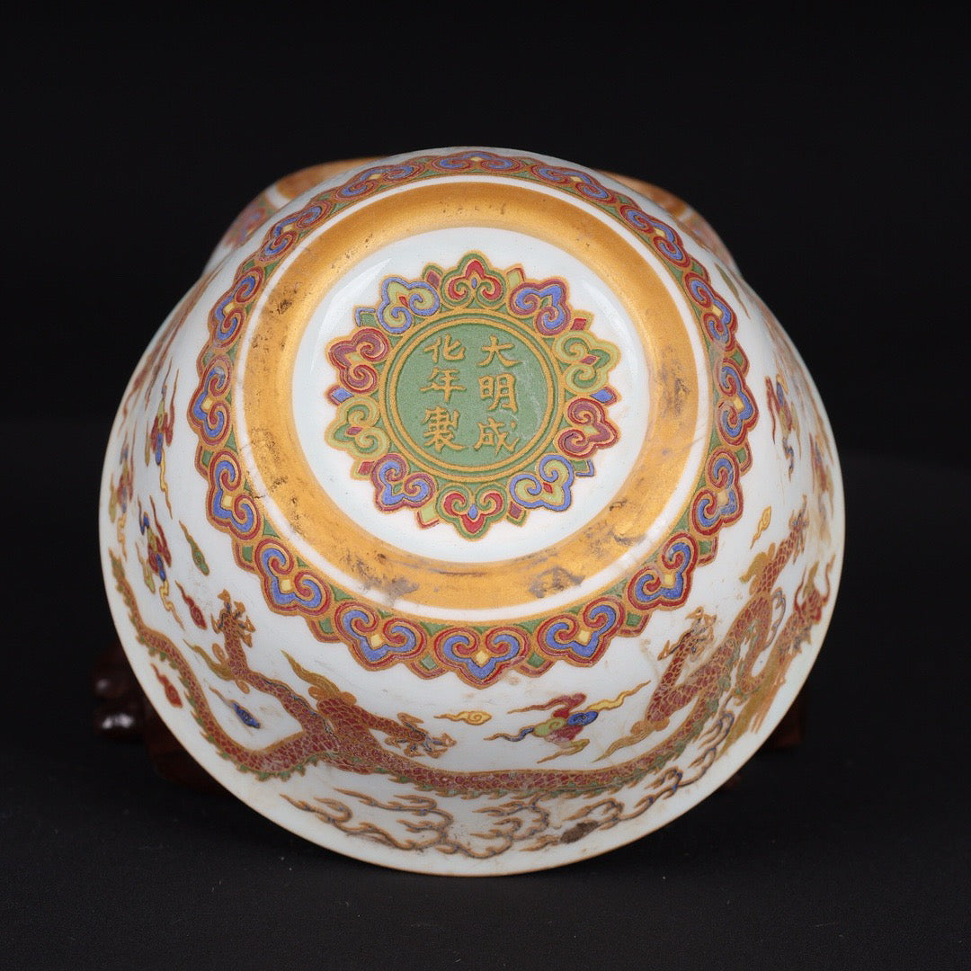 A pair of Chinese antique flat bottomed cups with patterns of double dragons playing with pearls