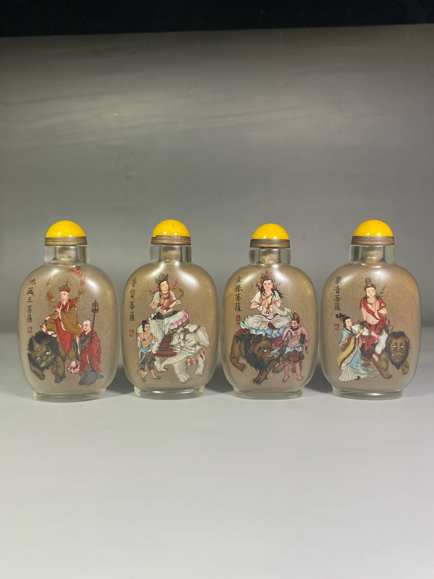 A set of Chinese antique glass inner paintings depicting the four great bodhisattvas and a snuff bottle