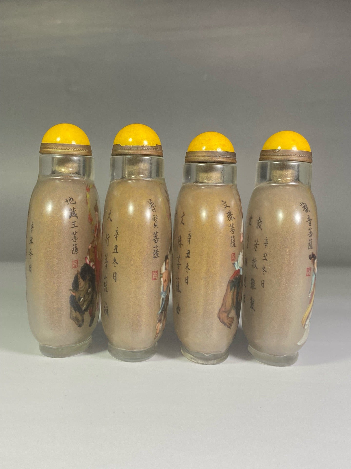 A set of Chinese antique glass inner paintings depicting the four great bodhisattvas and a snuff bottle