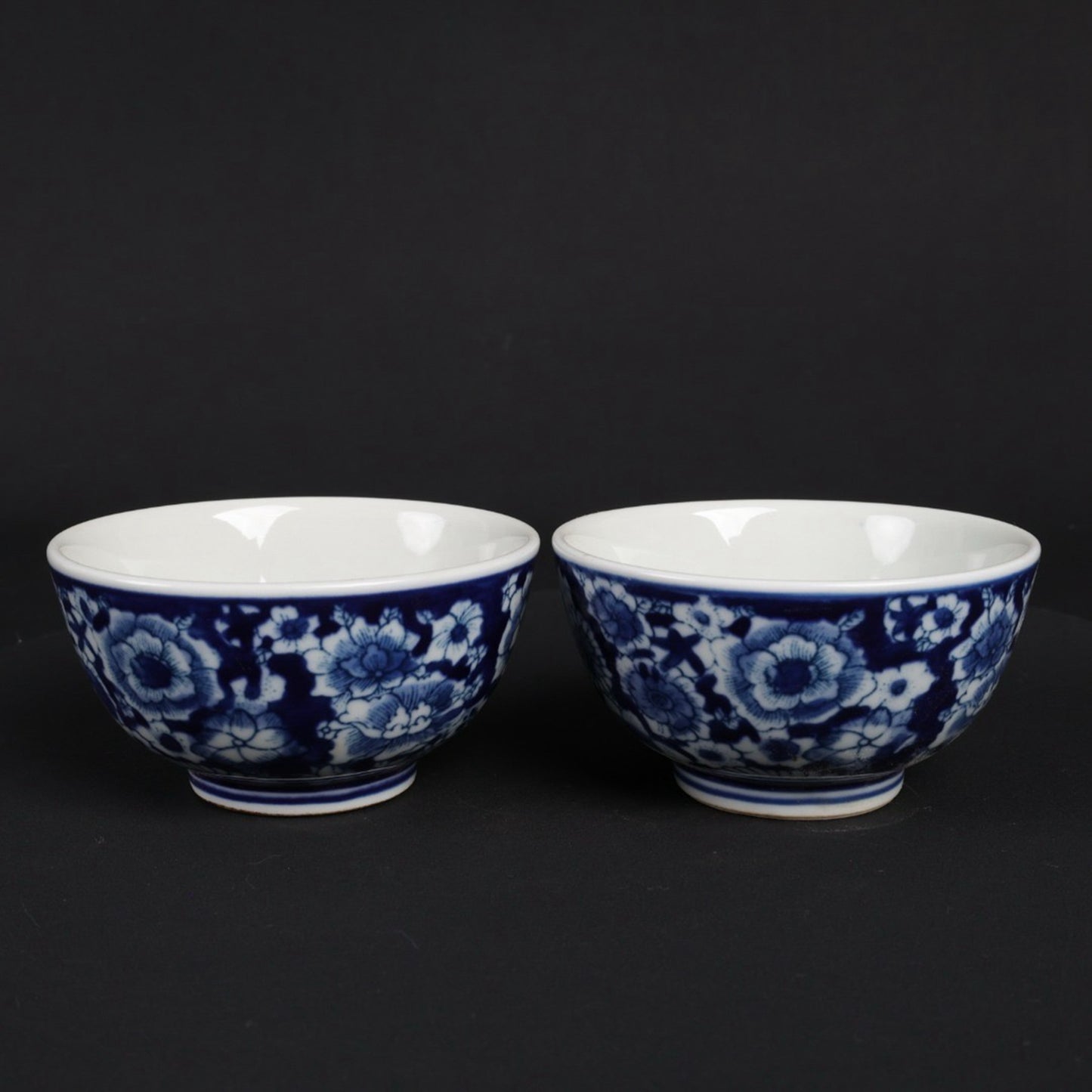 A pair of blue and white flower patterned cups