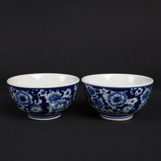 A pair of blue and white flower patterned cups