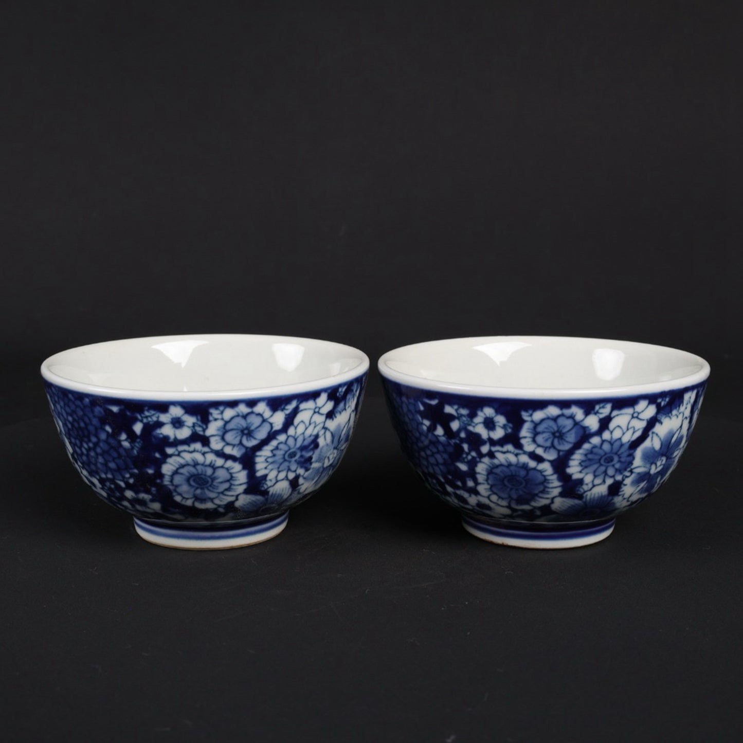 A pair of blue and white flower patterned cups