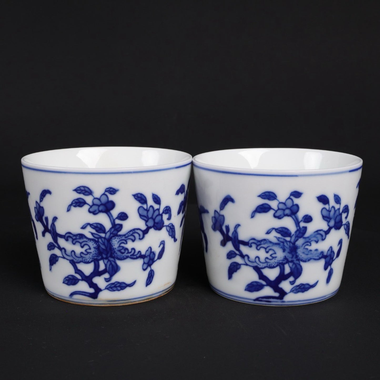 A pair of blue and white lucky, lucky, and longevity patterned cups